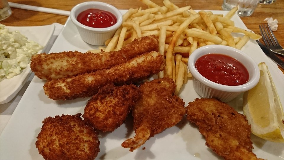 Fresh fish entrées on white plates.